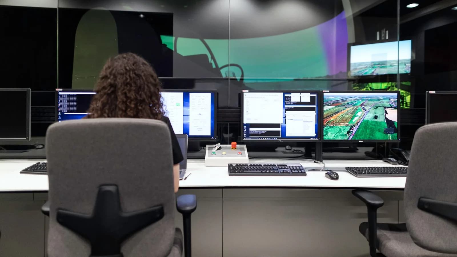 Operator monitoring live data across multiple screens in a control room, symbolizing engineered GTM systems